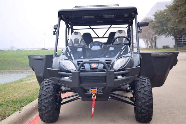 MAXIMUS 800cc 4-door UTV: Rugged utility vehicle with a black roll cage and off-road tires.
